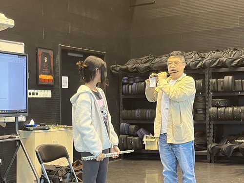 Now, Ringo is demonstrating the right way to play the flute.