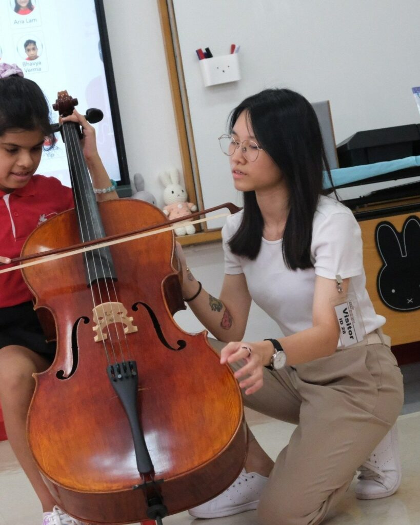 Sophie is having a cello with one of her students.